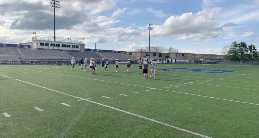 Coach Beckman instructs the boys LAX team.  