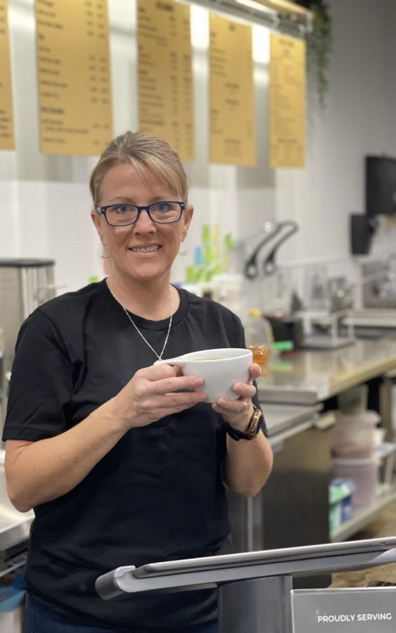 State Street Coffee owner Diane holding her favorite cup of coffee