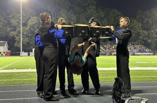 Pictured in this photo is Robert Eggebrecht performing the drumming stunt, assisting him is Jayden Ondrovich, Lucas Haag, Trevor Wagon, and Caleb Herb.