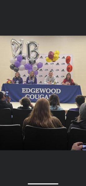 Cougars sign for college.  From left to right:  Peyton Steiniger, Kate Stephens, Hayden Honchul, and Aubree Brown.  
