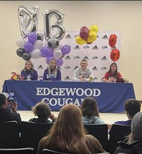 Cougars sign for college.  From left to right:  Peyton Steiniger, Kate Stephens, Hayden Honchul, and Aubree Brown.  