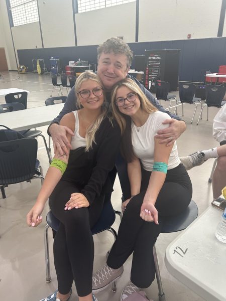 DECA Advisor Rocky Chassteen is proud of his students Kamdyn Buck and Lilly Fryman for participating in the blood drive.  