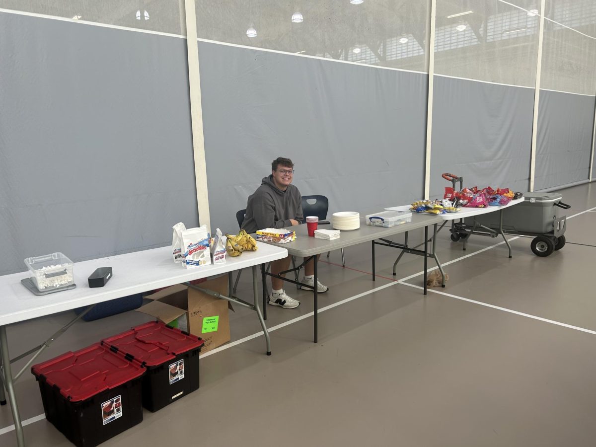 Deca President Luke Halsey seated at the snack table.