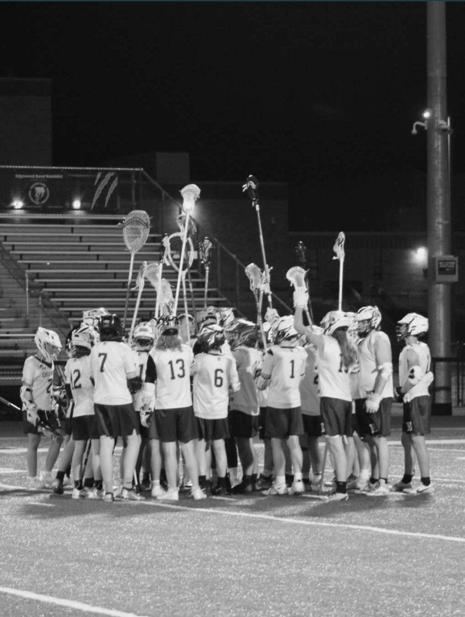 Boys Lacrosse Team in a huddle, Courtesy of Mason McQueen